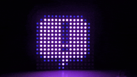 An LED matrix showing purple text